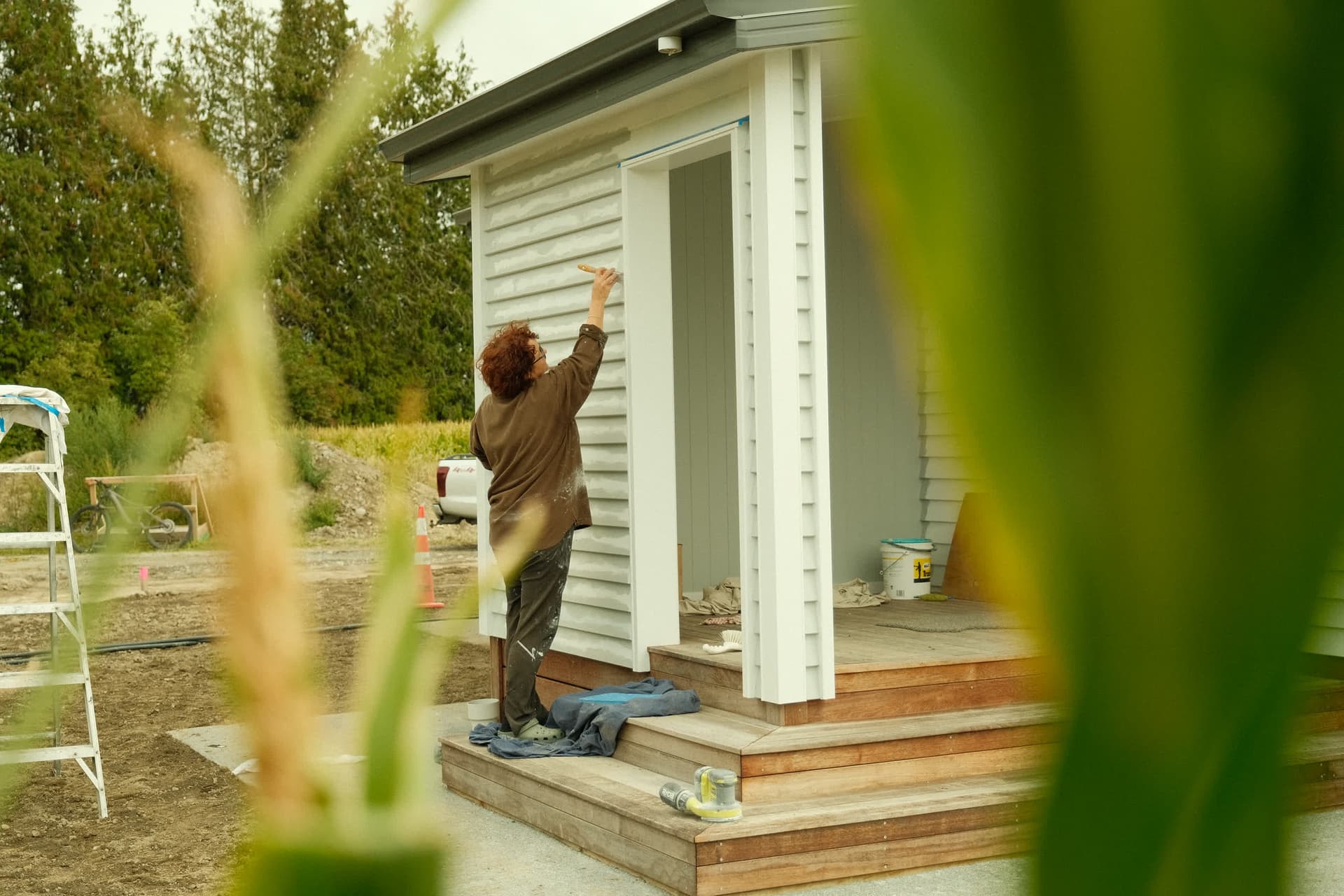 Jen painting the cottage
